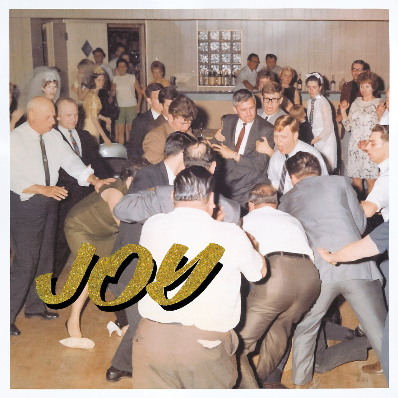 Idles - Joy As An Act Of Resistance (1LP) Vinyl Record
Vintage-style photo of a crowded room with people dancing, overlaid with the word 'JOY'.