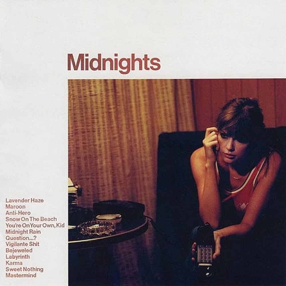 Taylor Swift - Midnights Vinyl Record
Album cover for 'Midnights' featuring a woman sitting on a couch with a phone.