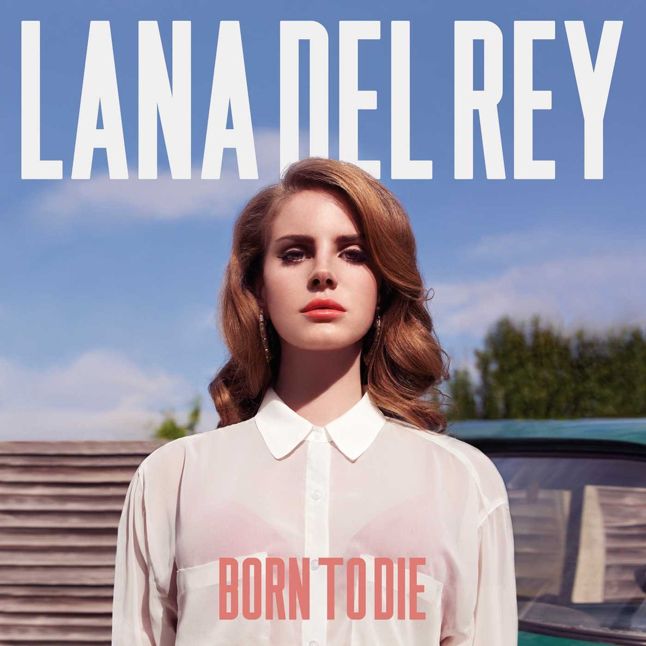 The image features the cover of the album "LANA DEL RAY - BORN TO DIE (THE PARADISE EDITION)." The cover artwork displays a striking image of Lana Del Rey, who is depicted in a vintage-inspired pose with a mix of melancholy and elegance.