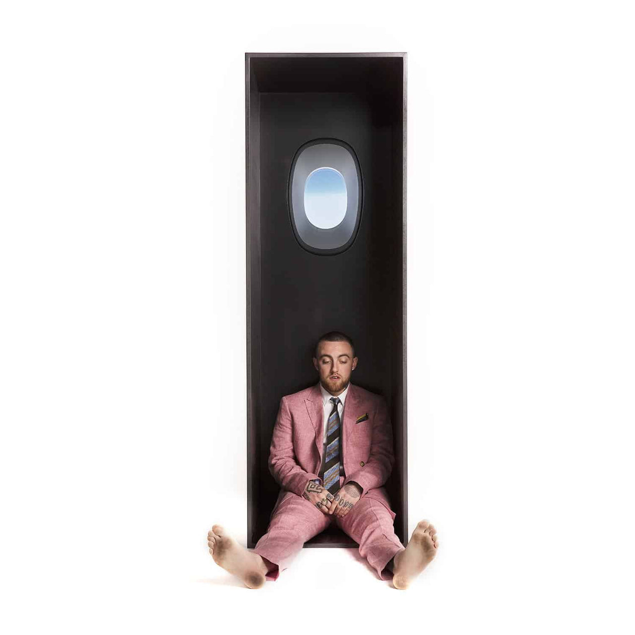 The album cover displays a man in a pink suit.