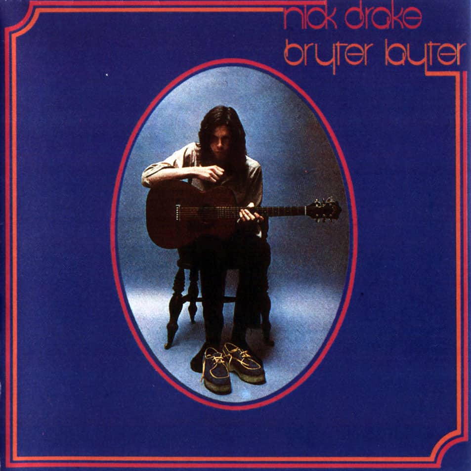 a person sitting in a chair playing a guitar