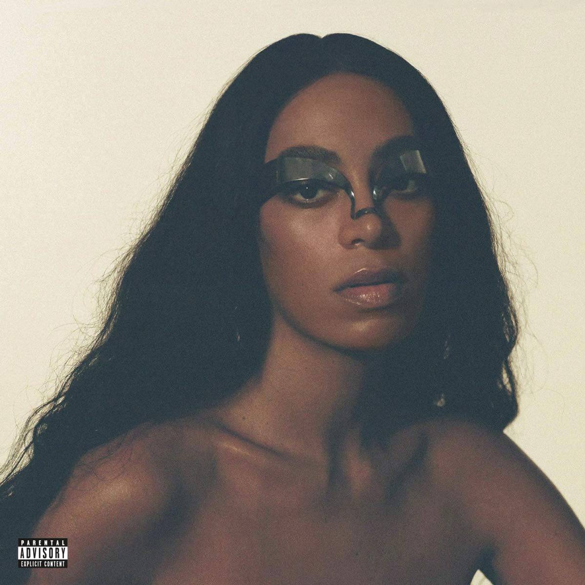 a woman (Solange) with an eye accessory on her face