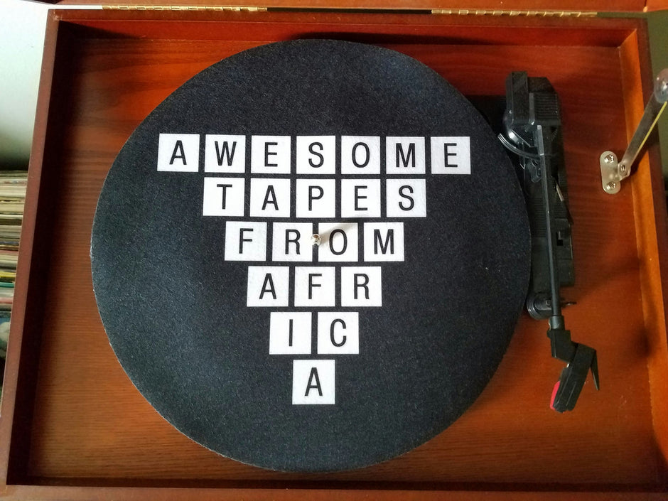 A turntable slipmat with the logo - Awesome tapes From Africa