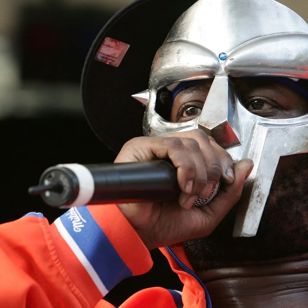 Close-up of MF DOOM holding a microphone while performing