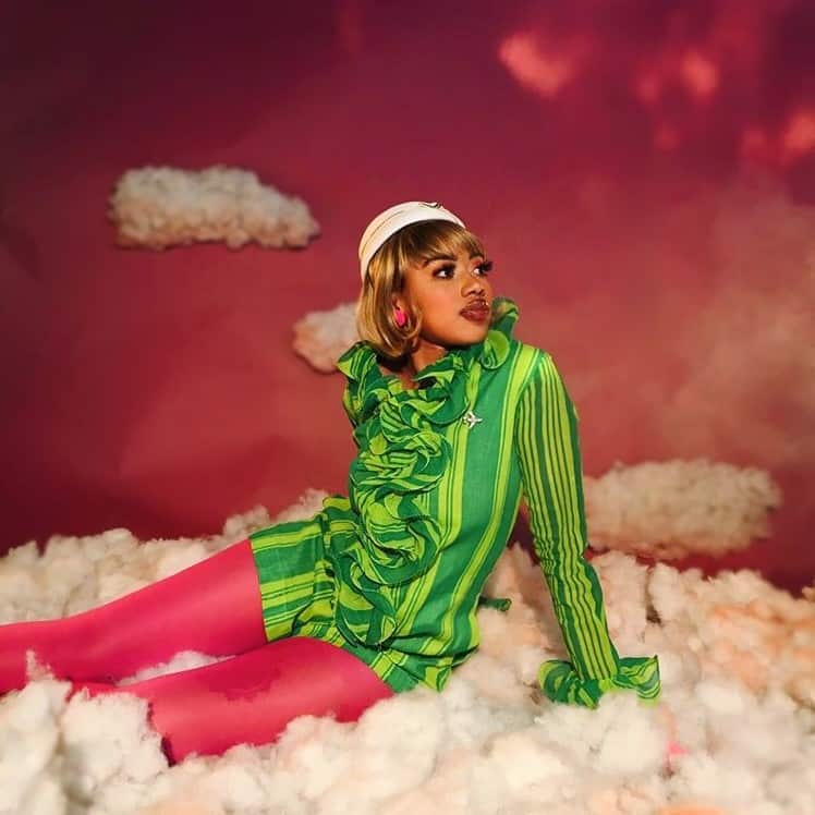 a person sitting on a cloud of cotton
