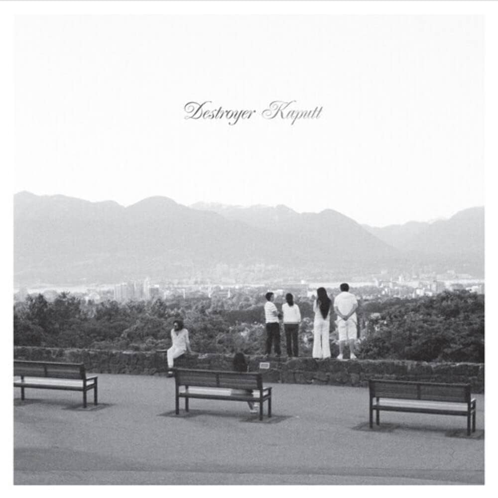 Album cover displaying individuals seated on benches and standing while enjoying the view of the mountains and the city