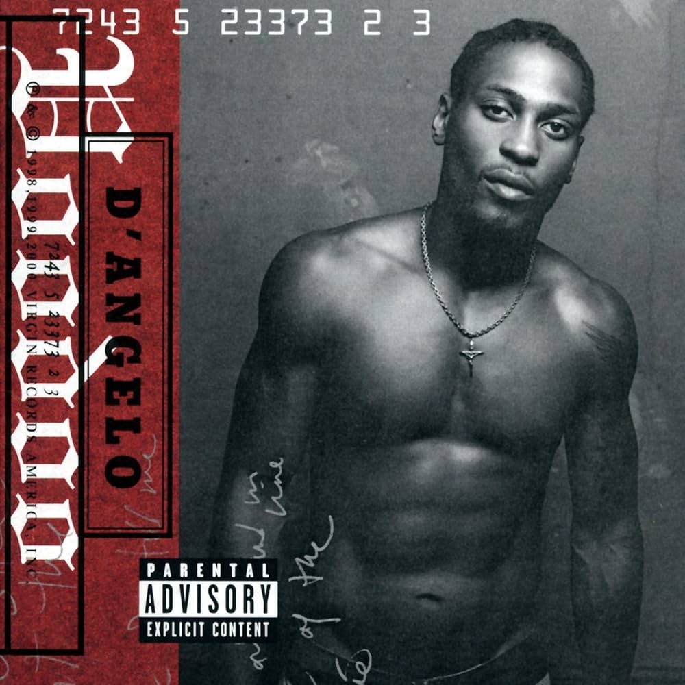 Image of a shirtless man with braided hair and a necklace, featured on an album cover with parental advisory label.