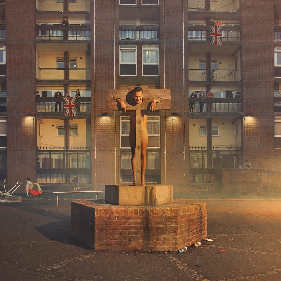 a person on a cross in front of a building